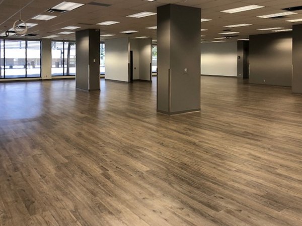 Completed open-plan office tenant improvement with plank flooring